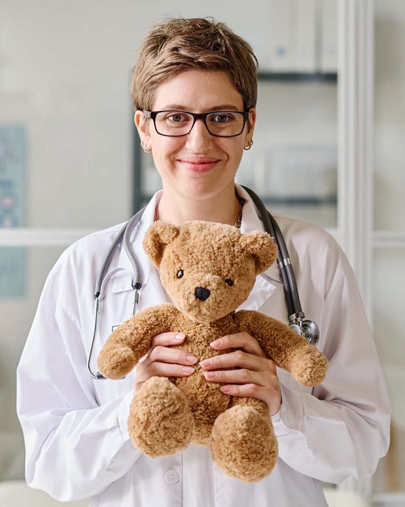 female-pediatrician-with-toy-at-office-RMUEPMB-819x1024