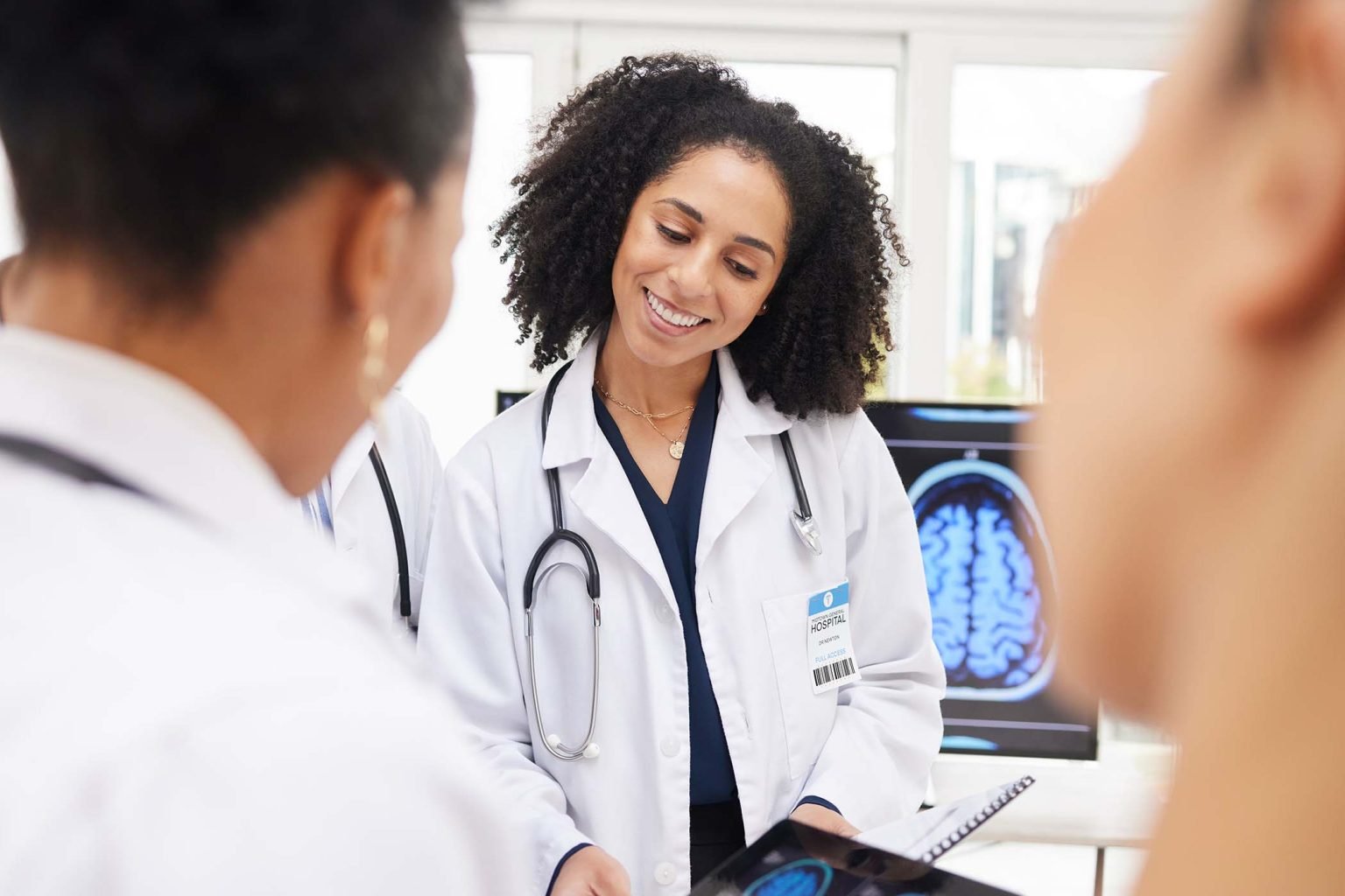 happy-woman-doctor-and-tablet-with-brain-scan-in-TDPN7DF-1536x1024