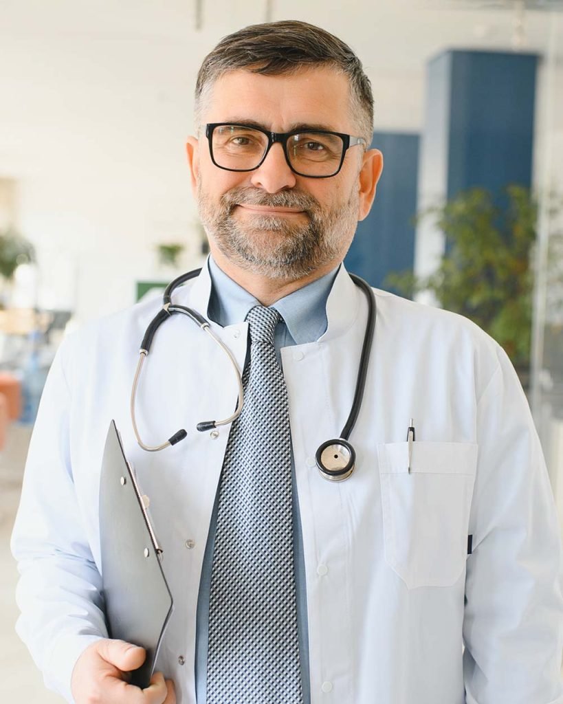 senior-in-a-hall-doctor-in-a-uniform-man-in-a-gl-JJGCLQ6-819x1024